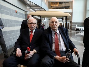 Berkshire Hathaway Chairman Warren Buffett, left, and Vice Chairman Charlie Munger are seen at the annual Berkshire shareholder shopping day in Omaha, Nebraska, in 2019.