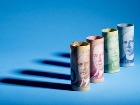 Canadian banknotes depicting Former Prime Minister Sir Robert Borden, from left, Former Prime Minister William Lyon Mackenzie King, the Queen of England Elizabeth II, and Former Prime Minister Sir Wilfrid Laurier are arranged for a photograph.