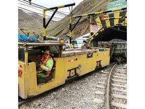 Train emerging from Yauricocha Tunnel loaded with ore