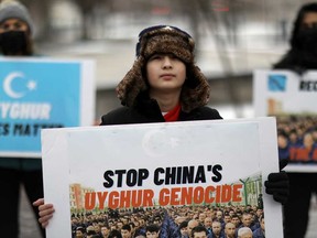 People take part in a rally in February outside the Canadian Embassy in Washington, D.C. to encourage Canada and other countries to label China's treatment of its Uighur population and Muslim minorities as genocide.