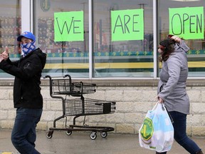 Signs show that a Dollarama store in Toronto remains open during Ontario's second state of emergency. COVID-19 restrictions, however, did dent traffic at its stores.