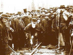 Lord Strathcona drives spike at completion of CPR transcontinental railway track  on Nov. 7, 1885 at Craigellachie, British Columbia.