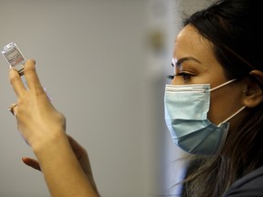 Nurse Brenda Lotakoun draws a dose of the Moderna COVID-19 vaccine as nurses from Humber River Hospital staff administer vaccines to residents, staff, and volunteers at one of B'nai Brith Canada's affordable housing buildings on March 23, 2021 in Toronto, Canada.