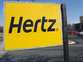 A yellow Hertz sign outside a Hertz Car Rental in New York City.