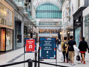 People walk in Toronto's Eaton Centre in June.