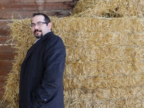 Farmers Edge CEO Wade Barnes in 2016 in front of bales of hay.