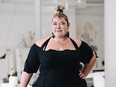 Anne-Marie Chagnon posing in her studio wearing a black dress.