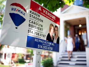 A view shows a sign of a house for sale as a real estate agent shows it to a client, amid the coronavirus disease (COVID-19) outbreak, in Montreal.