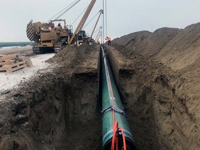 Pipe is laid for the Trans Mountain pipeline expansion project near Edmonton in late December 2019.
