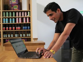 Socrates Rosenfeld, founder and CEO of Jane Technologies, scrolls the website for Harborside on a laptop at the dispensary in San Leandro, California