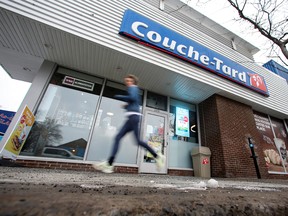 A runner passes a Couche-Tard convenience store in Montreal.