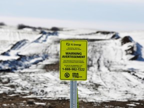 A sign is seen as the route of the Keystone XL crude oil pipeline lies idle through a farmer's field near Oyen, Alberta.