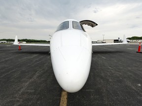 A Bombardier Learjet on airport tarmac.