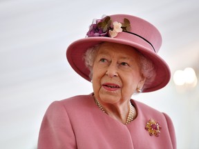 Queen Elizabeth wearing a pink hat and coat.