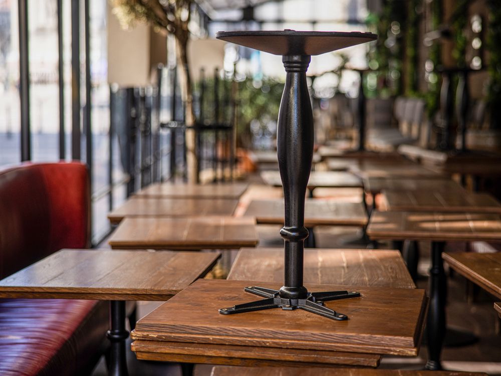 Stacked tables inside a closed restaurant.