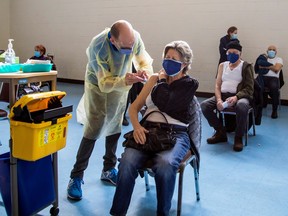 A nurse from Humber River Hospital administers the Pfizer/BioNTech COVID-19 vaccine at St Fidelis Parish in Toronto.