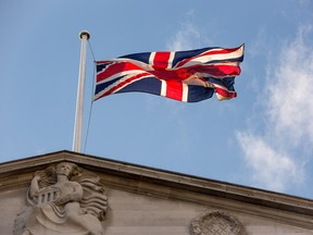 A British flag flies from the top of the Bank of England.