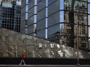 A pedestrian walks past the Bank of Canada building in Ottawa.