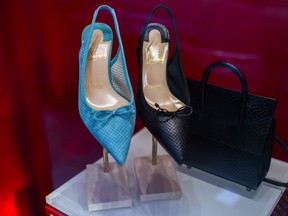 omen's high heel shoes and a handbag in a Christian Louboutin SAS luxury goods store in Paris.