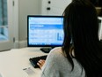 A woman looking at a computer screen