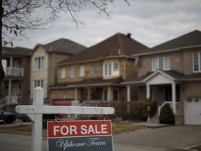 A For Sale sign in front of a row of homes in Vaughan, Ont.