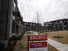 A "Sold" sign in front of a row of homes in a subdivision in Vaughan, Ont.