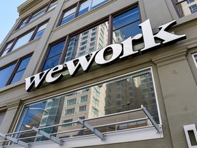A WeWork logo is seen outside its offices in San Francisco, California.