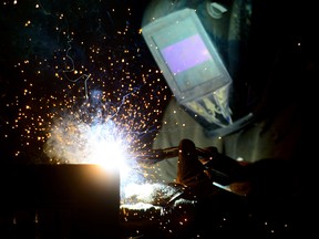 A welder fabricates a steel structure at an iron works facility  in Ottawa. Materials and resources are going to boost Canadian exports and economy amid new stimulus plans across North America.