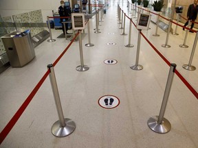 An empty security queue with social distancing markers is seen at Toronto Pearson International Airport. Passengers typically make up about 90 per cent of airport revenue, but during the pandemic, travel plummeted to 10 per cent of normal levels while airports remained open to manage essential travellers and cargo.