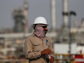 An employee looks on at Saudi Aramco oil facility in Abqaiq, Saudi Arabia. Aramco is looking to sell as much as 49 per cent stake of its pipeline business.