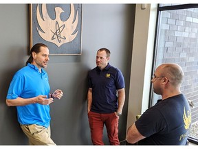 Greg Piefer, CEO of SHINE (left), talks with Evan Sengbusch, general manager of SHINE's Phoenix division, and Ross Radel, chief technology officer and chief operating officer of the Phoenix division, at the Phoenix headquarters and manufacturing center in Fitchburg, Wis., on April 16, 2021.
