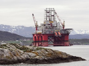 Oil rig in norwegian fjord  landscape.