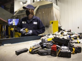 A worker sorts batteries at the Li-Cycle lithium-ion battery recycling facility in Kingston, Ontario.