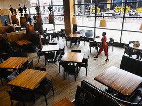 General manager Maggie Kiwanuka walks the floor inside Joey Don Mills Grill and Lounge as Ontario prepares for its third province wide lockdown during the COVID-19 pandemic in Toronto on Thursday, April 1, 2021.