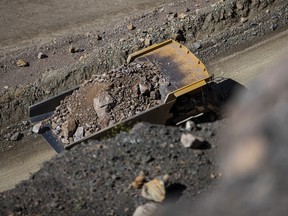 A dump truck moves raw ore inside the pit at the Mountain Pass mine, operated by MP Materials, in Mountain Pass, California.