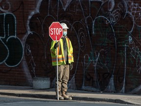 A construction worker holds a stop sign in Toronto.