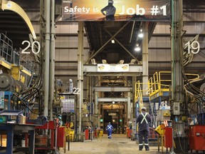 Safety reminders hang over a heavy hauler maintenance shop at Suncor Energy's base plant.