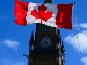 A Canada flag is pictured with the Peace Tower on Parliament Hill in Ottawa.