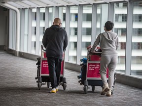 Travellers arrive at Toronto's Pearson International Airport in February.