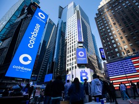 Monitors display Coinbase signage during the company's initial public offering (IPO) at the Nasdaq MarketSite in New York, Wednesday.