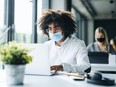 Workers wearing face masks in an office