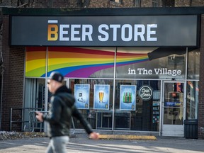 A pedestrian walks past a Beer Store location on Church Street in Toronto.