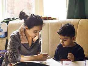 A mother working with her son on schoolwork