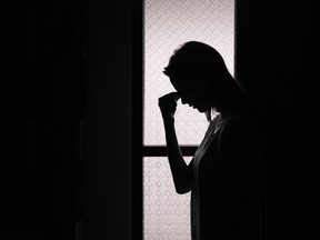 A depressed woman in a dark room