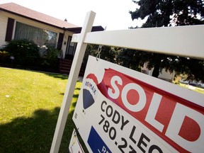 A real estate sign reading "sold" outside a home in Edmonton