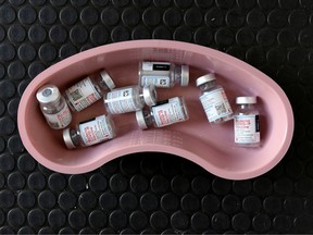 mpty vials of Moderna COVID-19 vaccine are pictured in a kidney dish