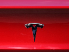 The Tesla logo is displayed on a Tesla car on April 26, 2021 in Corte Madera, California.