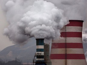 Smoke billows from smokestacks and a coal fired generator at a steel factory in China.