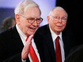 Berkshire Hathaway chairman Warren Buffett, left, and vice chairman Charlie Munger arrive at the annual meeting in 2013. This year's event will again be held online.