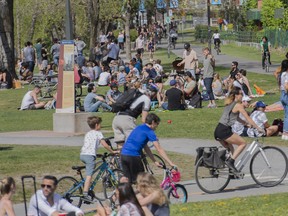 People gather next to the Lachine Canal on a warm spring day in Montreal, Saturday, May 15, 2021, as the COVID-19 pandemic continues in Canada and around the world.